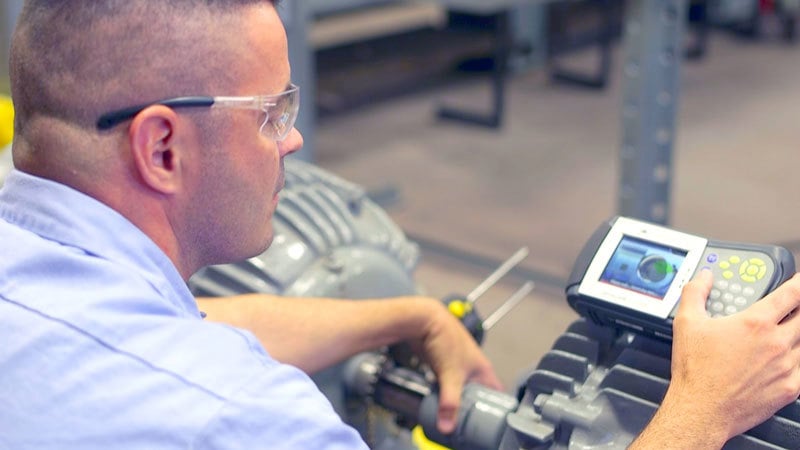Person aligning motor with laser