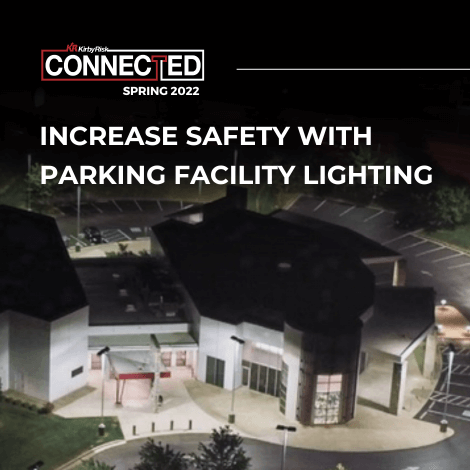 Commercial building with brightly lit parking lot with overlaid text saying increase safety with parking facility lighting